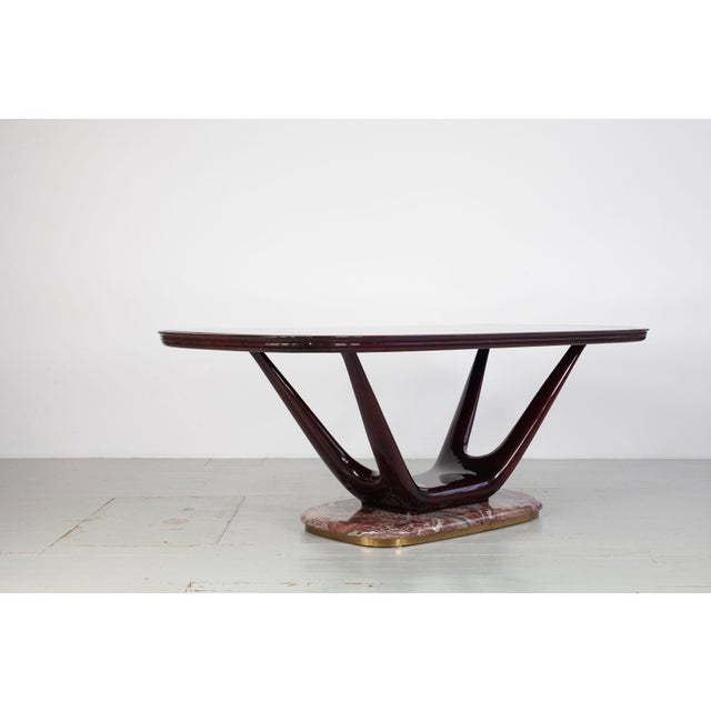 Dining table, designed by Fratelli Turri, Italy, 1950s. Elegant mid-century dining table with a frame made of dark-...