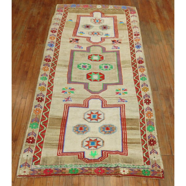 Gallery size Turkish Rug with an abrashed an field with 3 large medallions with predominant accents in neon green, coral,...