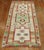 Gallery size Turkish Rug with an abrashed an field with 3 large medallions with predominant accents in neon green, coral,...