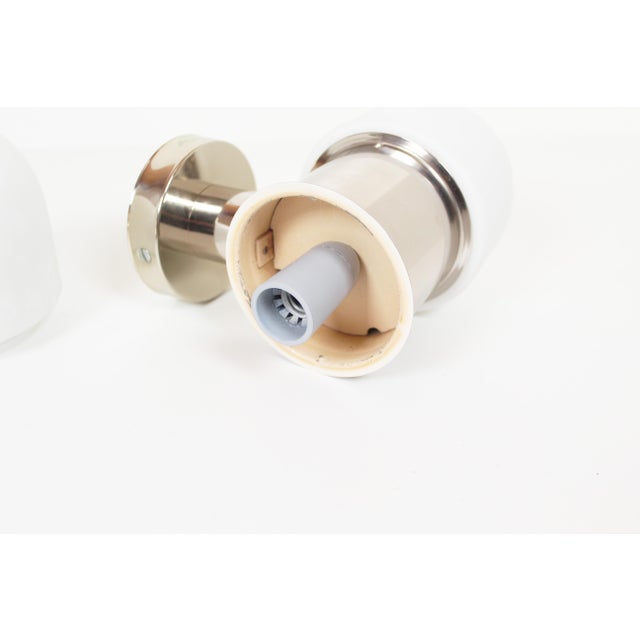 High-quality set of chrome-plated wall lamps with opaline glass by Rolf Kruger. Produced in Germany during the 1970s. Both...