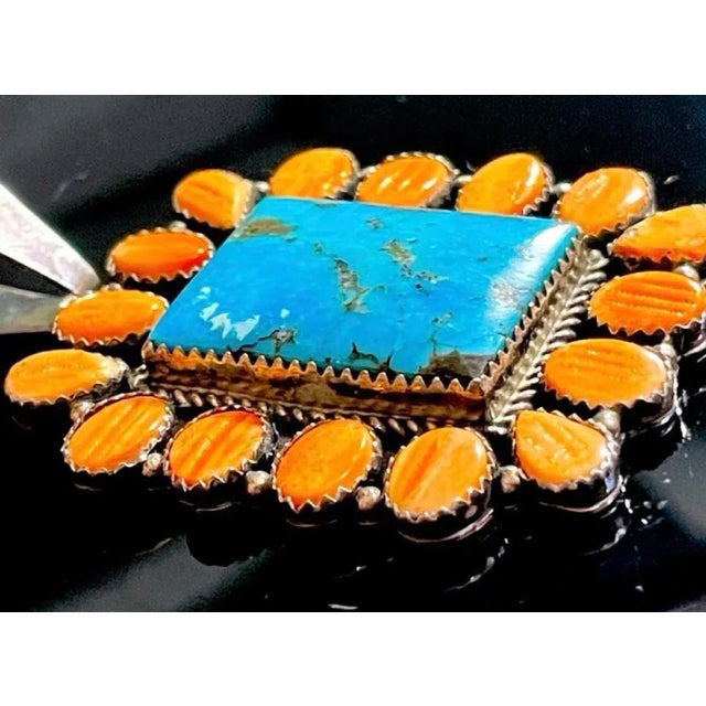 Navajo large Sterling silver rectangular pendant, signed Daniel Mike. The pendant displays 16 vibrant tangerine orange...