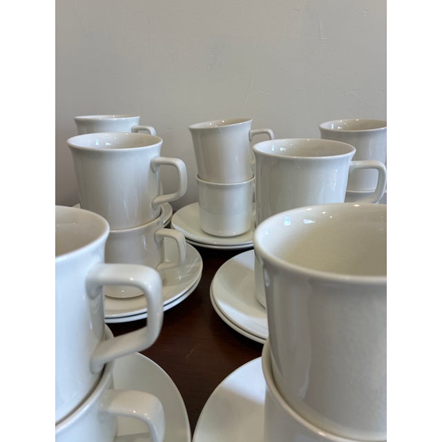 A beautifully understated set of vintage Johnson Brothers Tivoli cups and saucers in crisp white ceramic, offering...