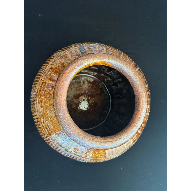 This substantial late Qing Dynasty Chinese storage jar is finished in a rich, dark brown glaze with subtle tonal variation...