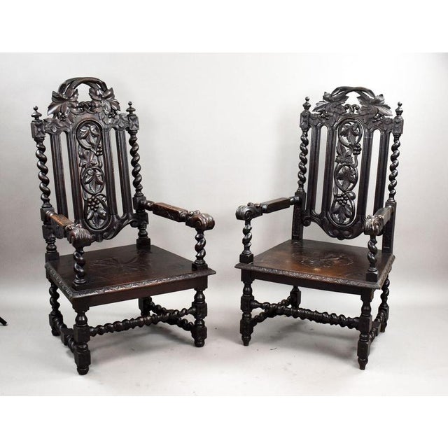 An exceptional near pair of late 19th-century carved oak throne chairs, richly detailed and full of period character....