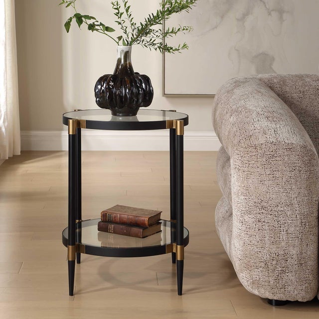 This Elegant Side Table Features A Sleek Black Iron Frame With Sophisticated Gold Accents. It Includes Two Tempered Glass...