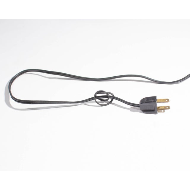 A desk or table lamp designed by Robert Sonneman. This articulated black lamp is counter-balanced and stands on a square...