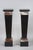A pair of pilaster sheaths in black and royal red marble with a stack of doucines at the top forming the presentation...