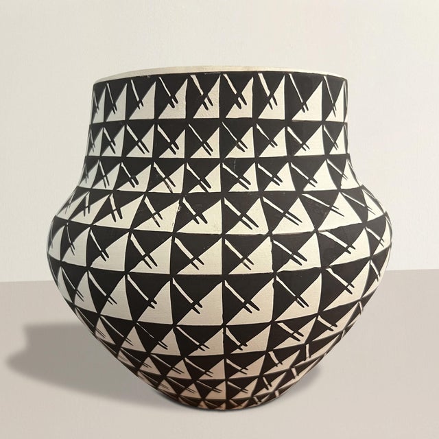 This late 20th-century Acoma Pueblo pottery bowl is a striking example of the artistry and craftsmanship synonymous with...