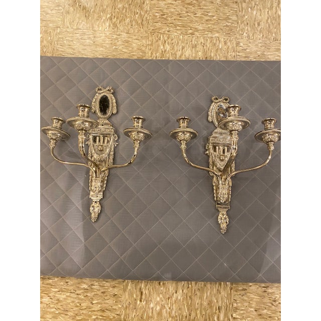 A pair of circa 1920’s Caldwell silver plate sconces neoclassical style with 3 lights