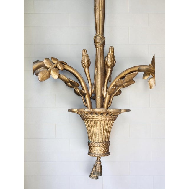Louis XVI style patinated gilt bronze chandelier Height 44 cm Width 37 cm Weight 2.4 kg Three rose-shaped tulip shades....