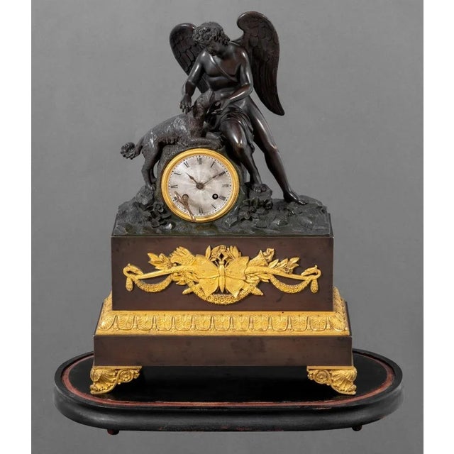 Charles X Patinated and Gilt Bronze Figural Clock, circa 1830, the circular silvered dial, the movement strike on bell,...