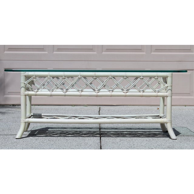 Add a breezy, retro vibe to your living space with this striking 1970s vintage coastal rattan coffee table. Featuring a...