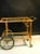 An elegant Italian bar cart in wood with beautiful hand-painted design. Gorgeous brass accents including spoke wheels,...