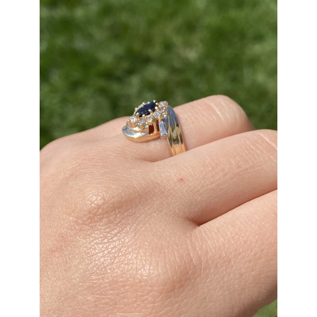 The Osborne Park: Yellow Gold Sapphire and Diamond Designer Ring. This vintage ring centers on a 0.40 carat marquise...