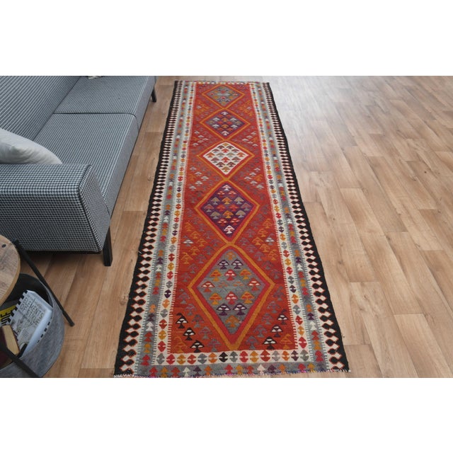 Vintage Hand-Knotted runner rug is a semi-antique vintage area rug. The '70s Eastern region of Anatolia's unique rug is...