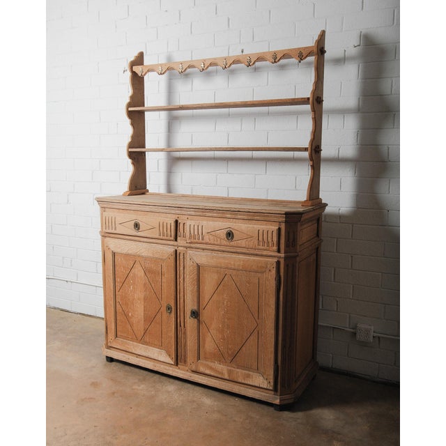 A charming 19th century French Provincial oak dresser with a beautifully aged patina and practical plate rack top. This...