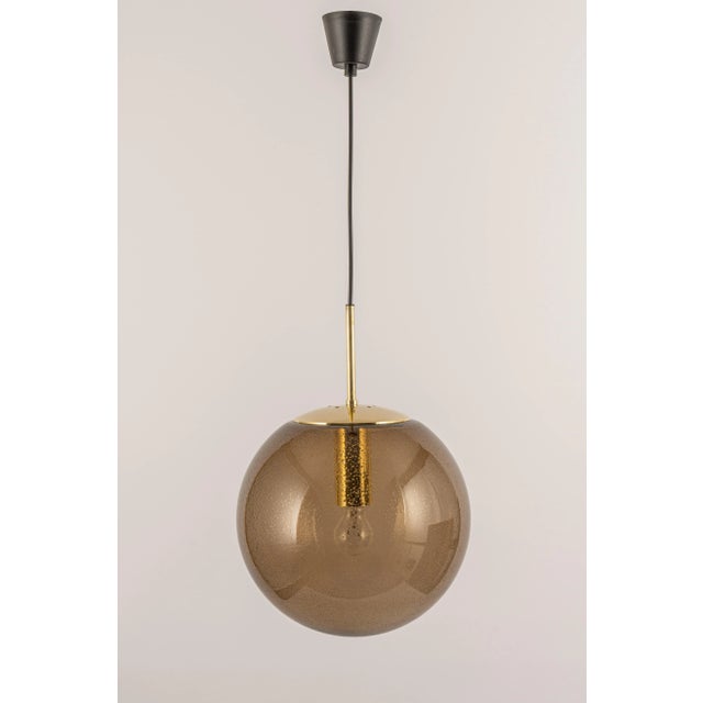 This is a large smoked glass ball (hand-made) pendant, manufactured by limburg, germany, from 1970 to 1979. The sockets...
