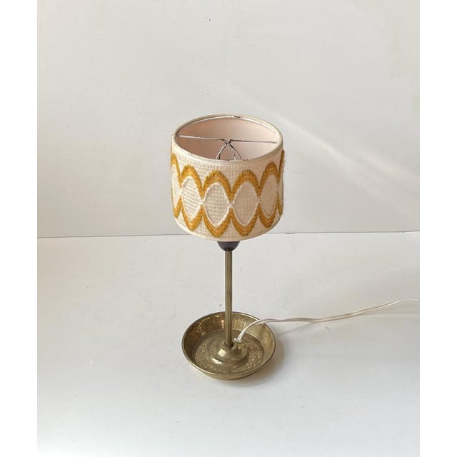 Flower power table light with ashtray base and equipped with a handmade textile shade with wool decoration. It was made in...