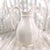 This is a large white porcelain pitcher that has a name on the base that I cannot read. I have included three pictures of...