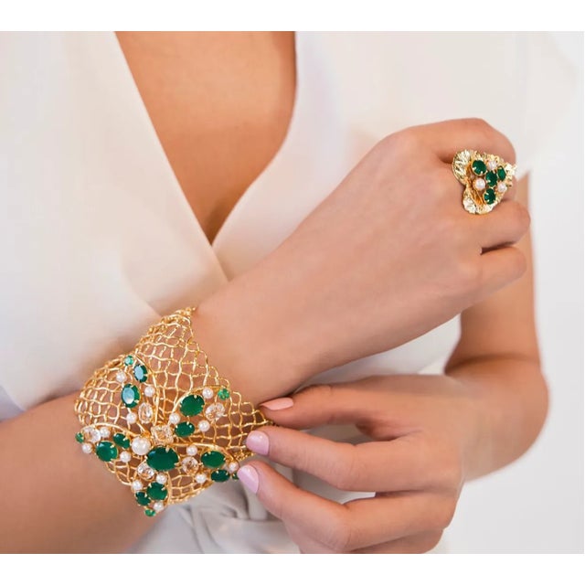 The Gianna Cuff, artfully crafted from semi-precious stones, showcases a distinctive net-style design with large flowers...