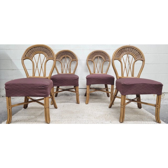 This is a set of four gorgeous vintage rattan bentwood dining chairs in a beautiful Coastal, Boho, or Tropical style with...