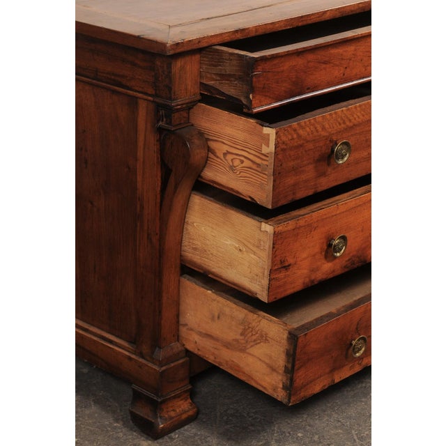 An Italian Empire carved wood chest of four drawers from the 19th century. This antique chest from Italy has a rectangular...