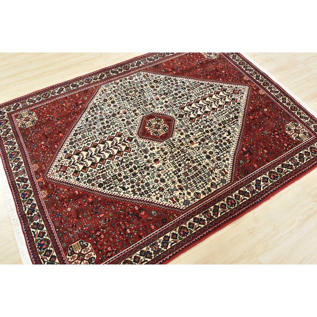 An authentic vintage tribal Abadeh rug hand-knotted with fine wool and natural dyes. This finely woven nomadic rug...