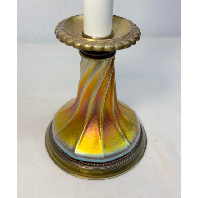 This vintage Tiffany Studios hand blown favrile lustre glass and brass electric table lamp is an absolutely stunning...
