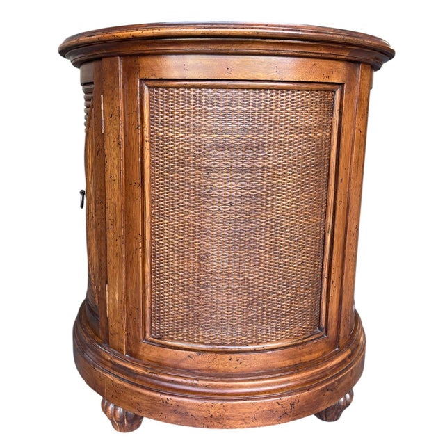 Vintage Lexington Tommy Bahama “Cayman” drum table featuring a warm honey-toned finish with woven rattan panels and a...
