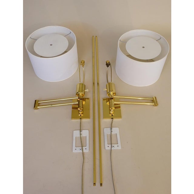 A brilliant and impressive matched pair of George Hansen New York articulating swing arm wall lamps circa 1950's....