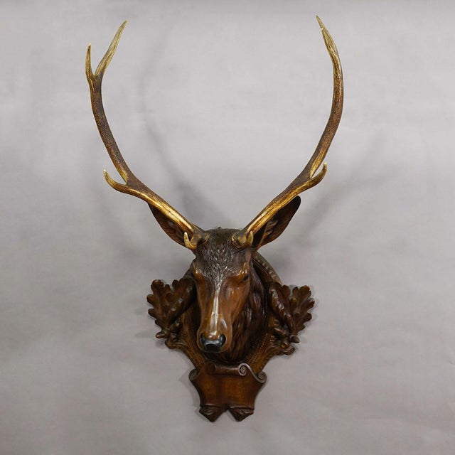 Large Naturalistic Black Forest Carved Stag Head, ca. 1920s A large antique wooden carved Black Forest stag head...