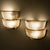 Pair of two-tier wall lights with shades in wavy clear glass and elegant brass mounts. Attributed to Archimede Seguso, the...
