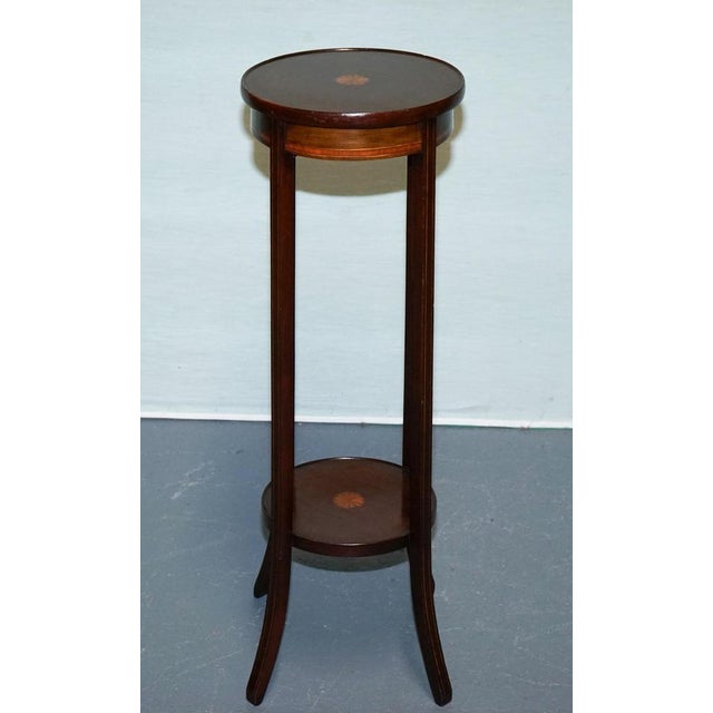 Antiques of London A fine antique hardwood two-tier plant stand dating to the early 20th century, featuring exquisite...