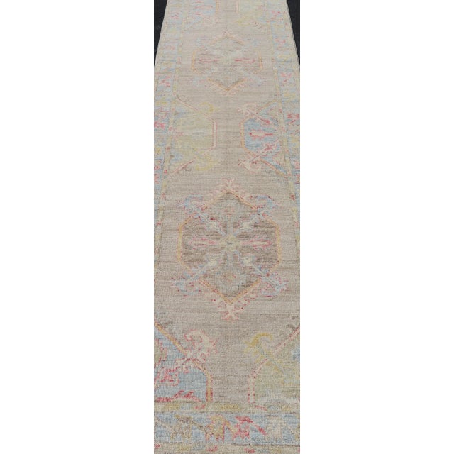 Textile Hand-Knotted Oushak Runner With Medallion Design on a Tan Field With Red & Blue For Sale - Image 7 of 13