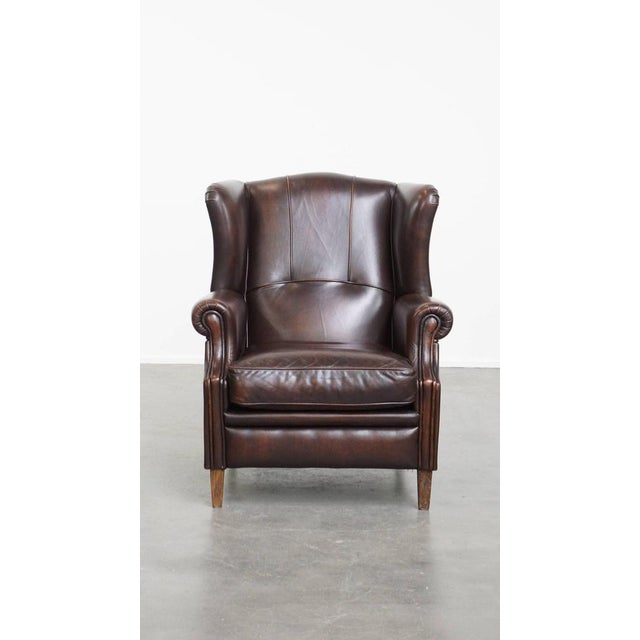 We offer this luxurious and comfortable English-style wing chair made of cowhide leather. This cowhide wing chair is a...