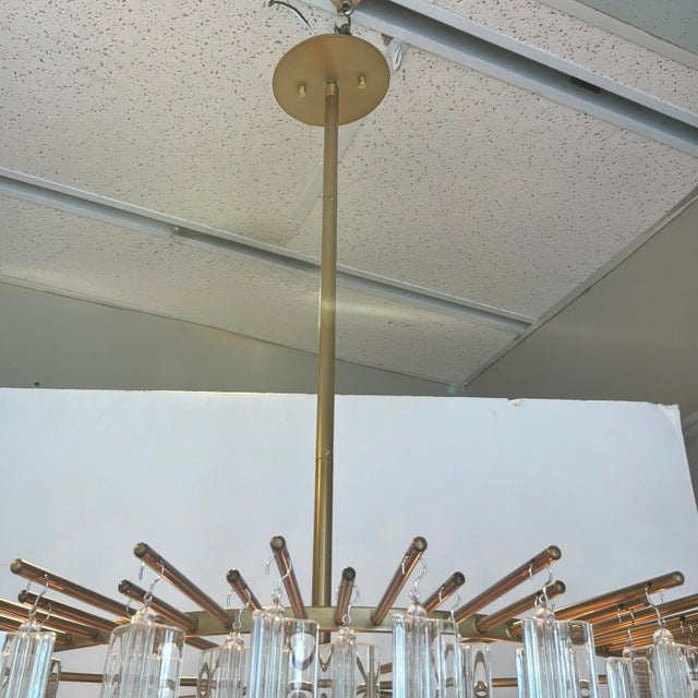 Original retail $3875, stylish Arteriors Modern Brass and Glass Nessa Round Chandelier, showroom floor sample