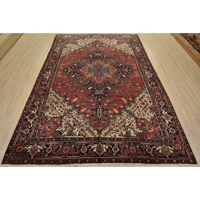 An authentic vintage traditional tribal Heriz rug hand-knotted with fine wool and natural dyes. This rug features a...