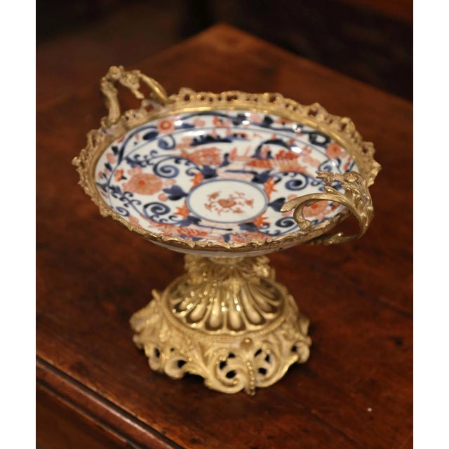 Elevate a console or center table with this refined antique Imari bowl mounted on an ornate gilt bronze stand, crafted in...
