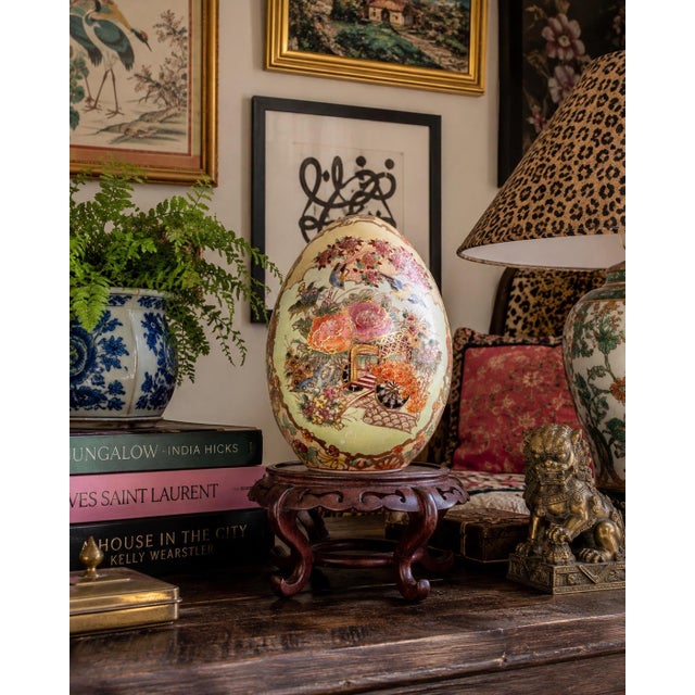This impressive decorative porcelain egg showcases an intricate hand-painted design inspired by traditional Chinese and...