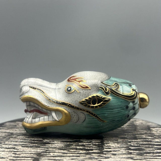 This is a charming and unusual vintage Chinese porcelain snuff bottle, crafted in the form of a dragon's head. The bottle...