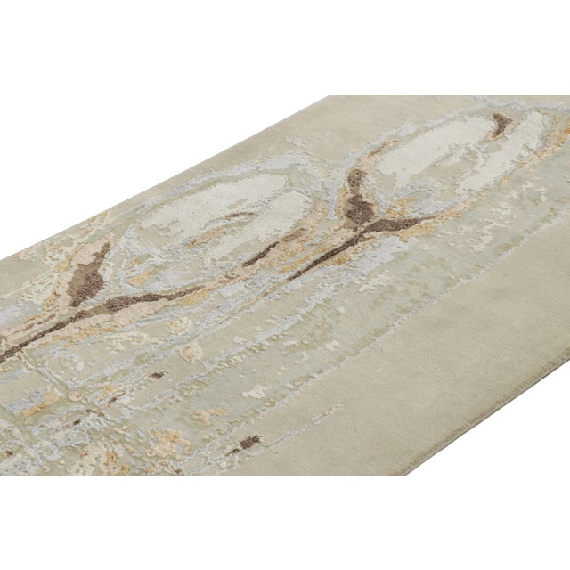 Hand-knotted in a blend of wool and lustrous silk, this 3x7 modern abstract runner rug is a bold new addition to the...