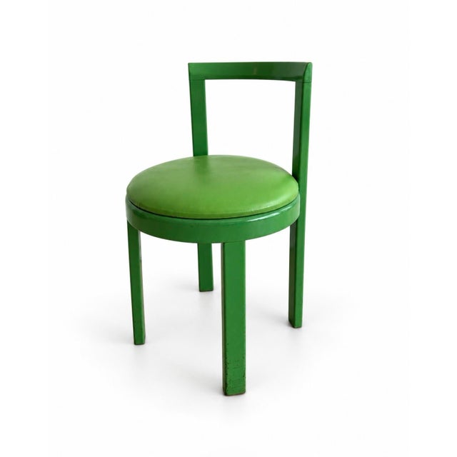 A striking set of four vintage Bruno Rey–style chairs in a vibrant green finish. Their curved backs, clean lines, and...