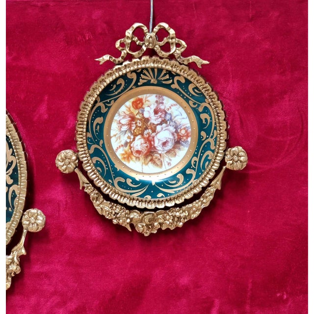 This beautiful set of three Baroque-inspired wall décor pieces features delicate floral artwork framed by rich bottle...