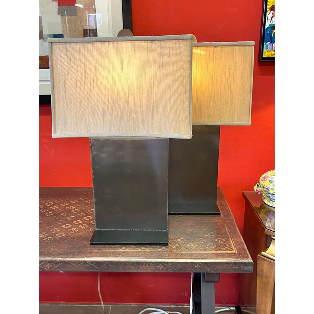 Pair of contemporary Chapman bronze and steel table lamps. Very simple but handsome design. A thin rectangle of bronze set...