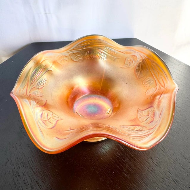 A stunning early 20th-century Fenton marigold carnival glass bowl featuring the sought-after “Blackberry Spray” pattern....