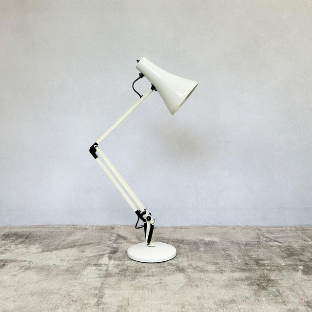 White Anglepoise Apex 90 desk lamp designed by George Carwardine, featuring press button on/off switch mounted on the...