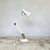 White Anglepoise Apex 90 desk lamp designed by George Carwardine, featuring press button on/off switch mounted on the...