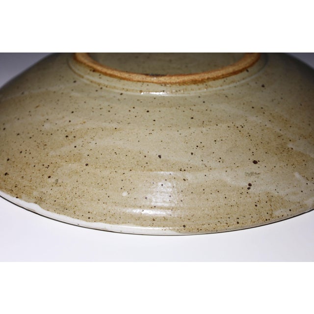 Large studio pottery platter with brown decorative dashes. Warren MacKenzie is known for simple, wheel-thrown functional...