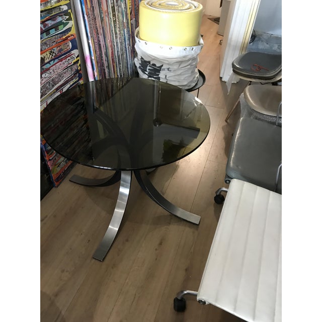 Beautiful side table in glass and steel. Height 60cm and diameter 90cm. Good overall condition I have official proof of...