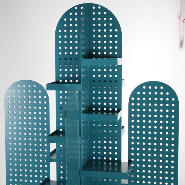 Stunning vintage perforated metal shelf in the shape of a turquoise blue cactus. Suitable for indoor or outdoor use, it...